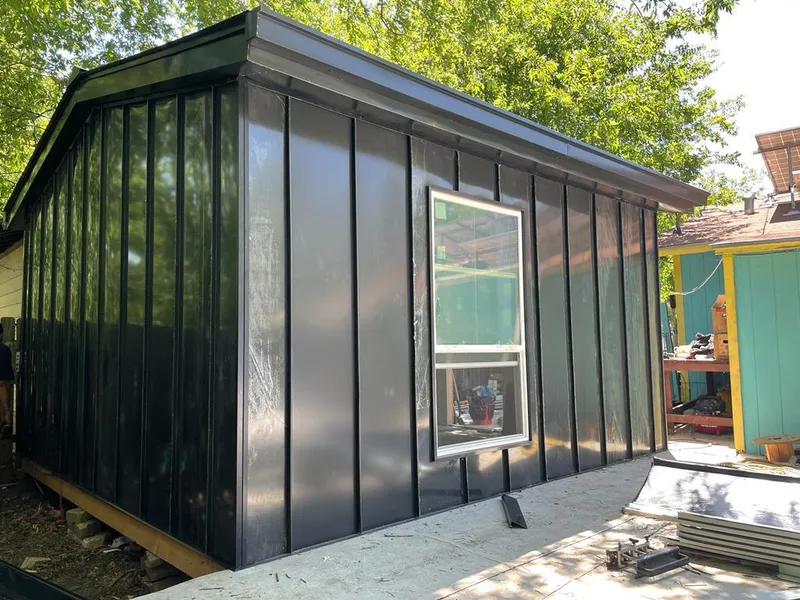 Black standing seam metal wall panels for Roof Inspection in Prosper