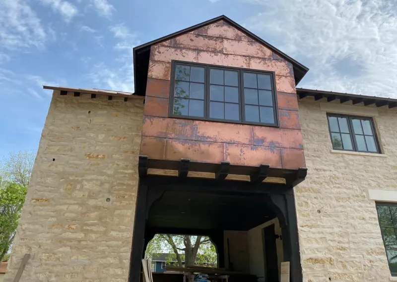 Copper metal panel facade on a stone building for Roof Repair in Prosper
