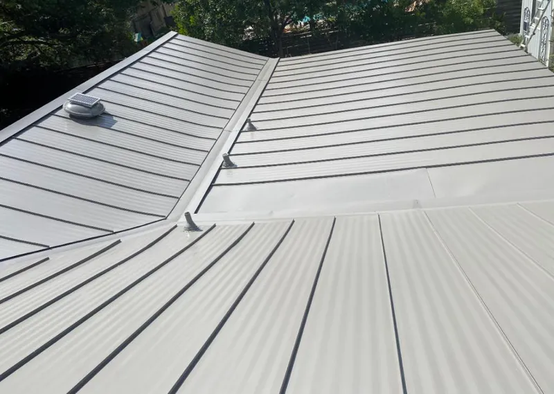 Solar attic fan installed on a metal roof for Roof Ventilation in Prosper